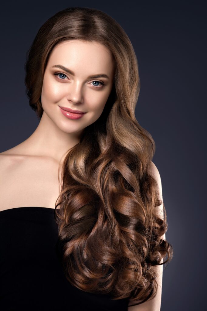 Beauty hair woman curly hairstyle natural makeup. Studio shot.