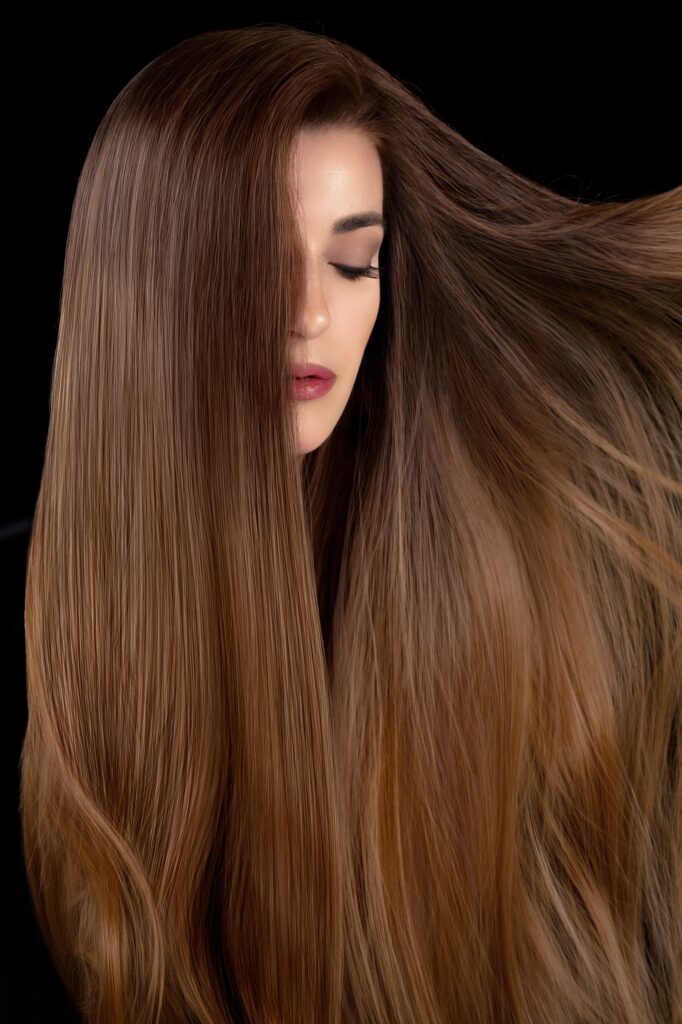 Healthy long hair. Beautiful model girl with shiny smooth and straight long hair. Hair care and keratin straightening, smoothing and treatment.