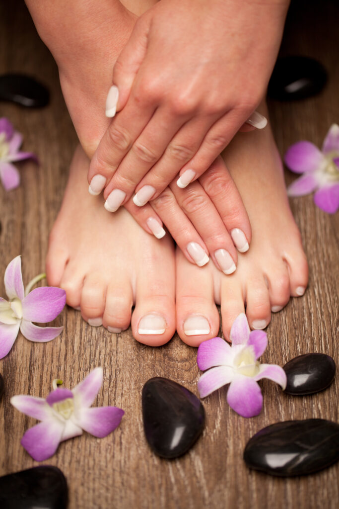 Relaxing pink manicure and pedicure with a orchid flower